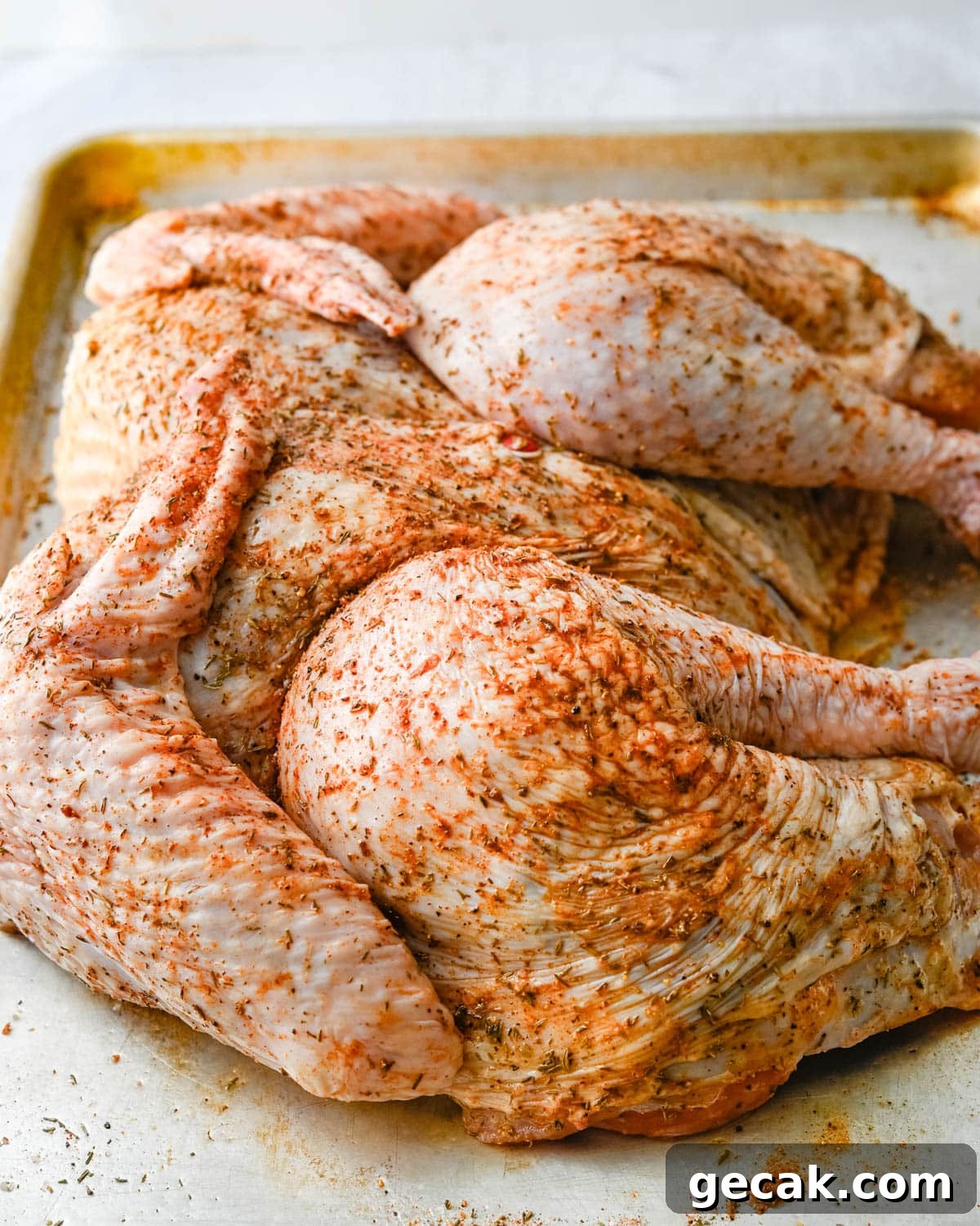 Rubbing the turkey with the rub.