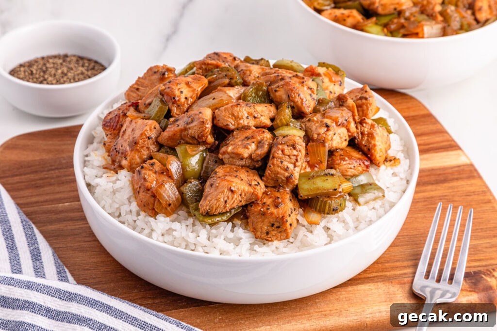 white bowl with black pepper chicken over rice