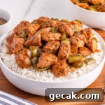 bowl of black pepper chicken over rice