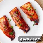 A platter of miso salmon topped with scallions and sesame seeds.
