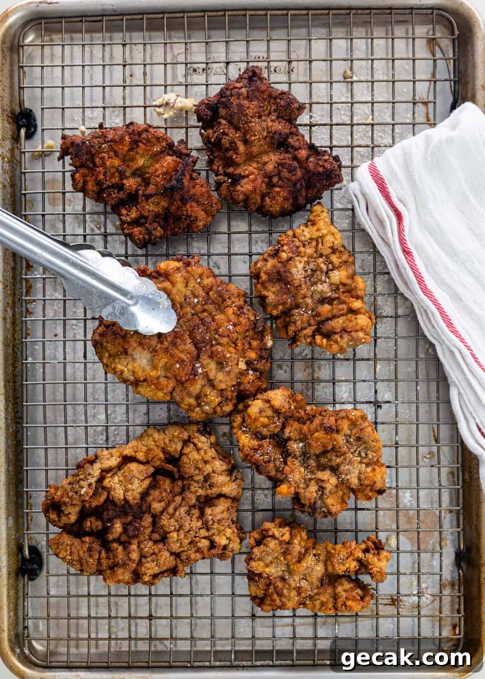 southern chicken fried steaks on wire rack out of the hot oil pan