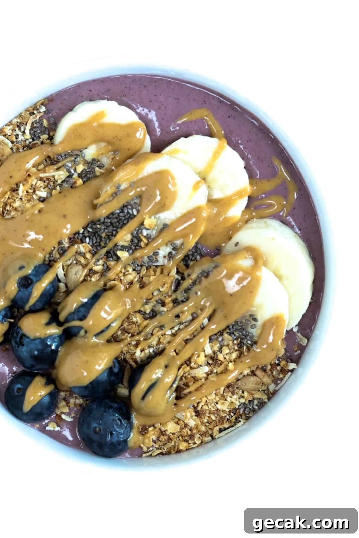 Top view of one acai bowl served in a white bowl.