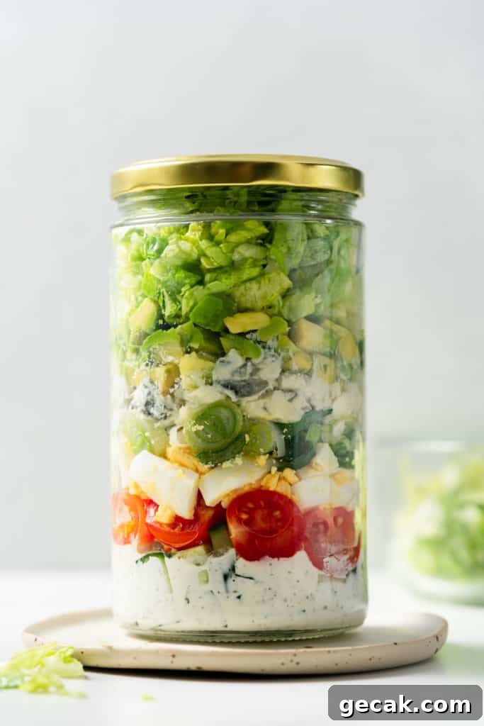 Vegetarian cobb salad jar closed with a gold lid.
