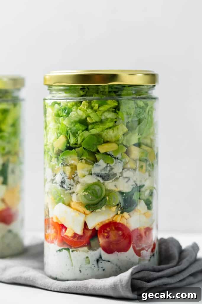 side shot of cob salad in a jar with lid on it