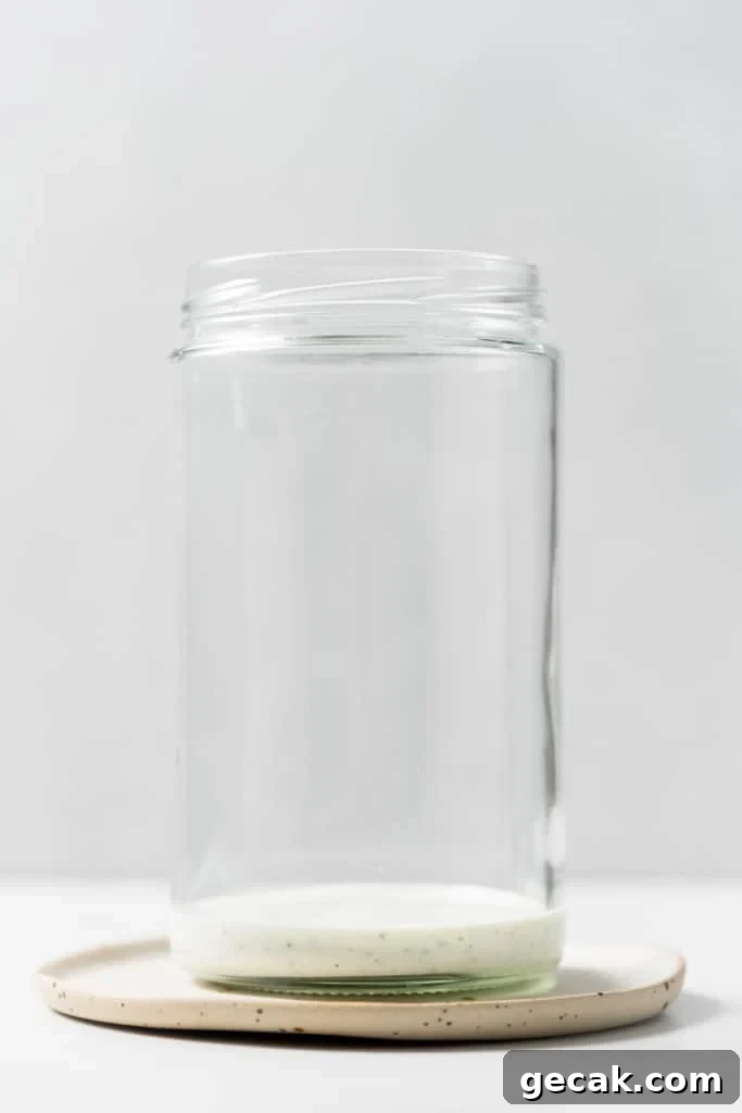 Adding dressing to a mason jar.