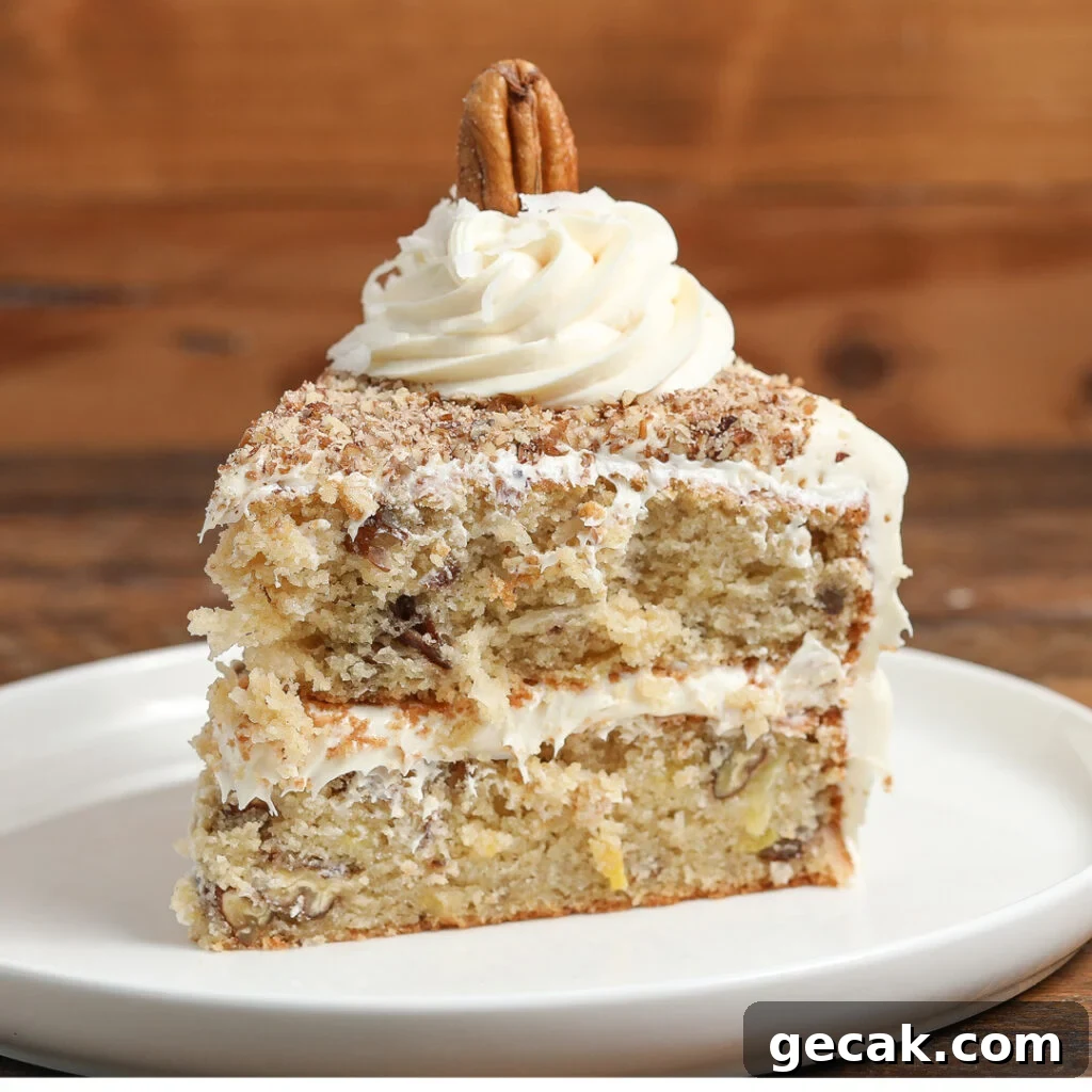 Slice of Italian Cream Cake with cream cheese frosting, coconut, and chopped pecans.