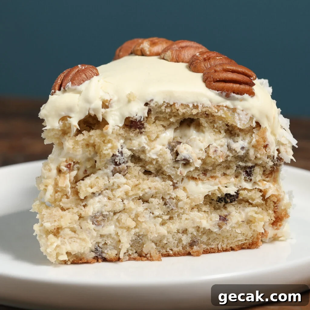 Close-up slice of Italian Cream Cake showing cream cheese frosting, pecans, and coconut layers