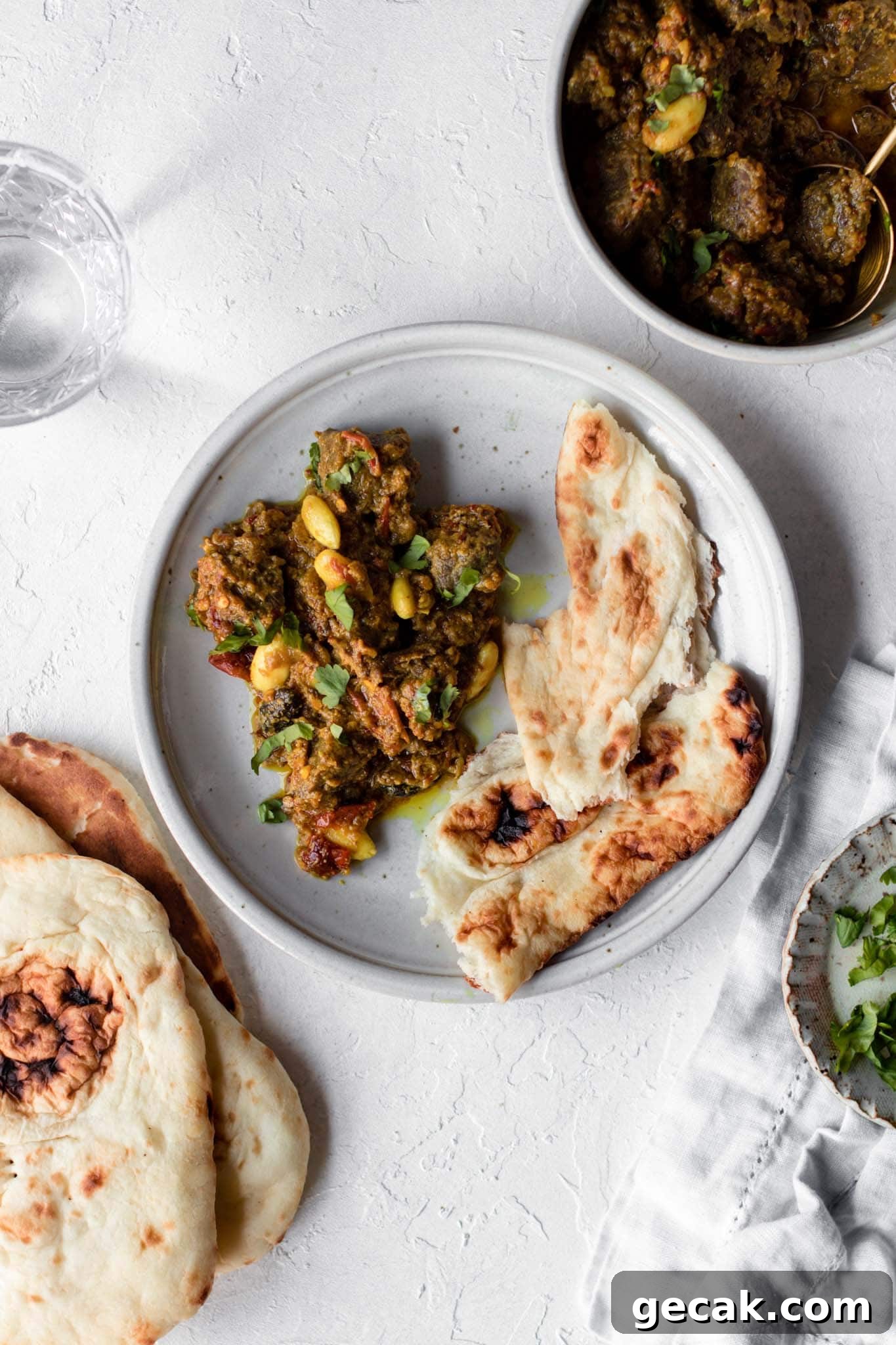 Pakistani style Beef Curry (Stew) on a plate with naan on the side