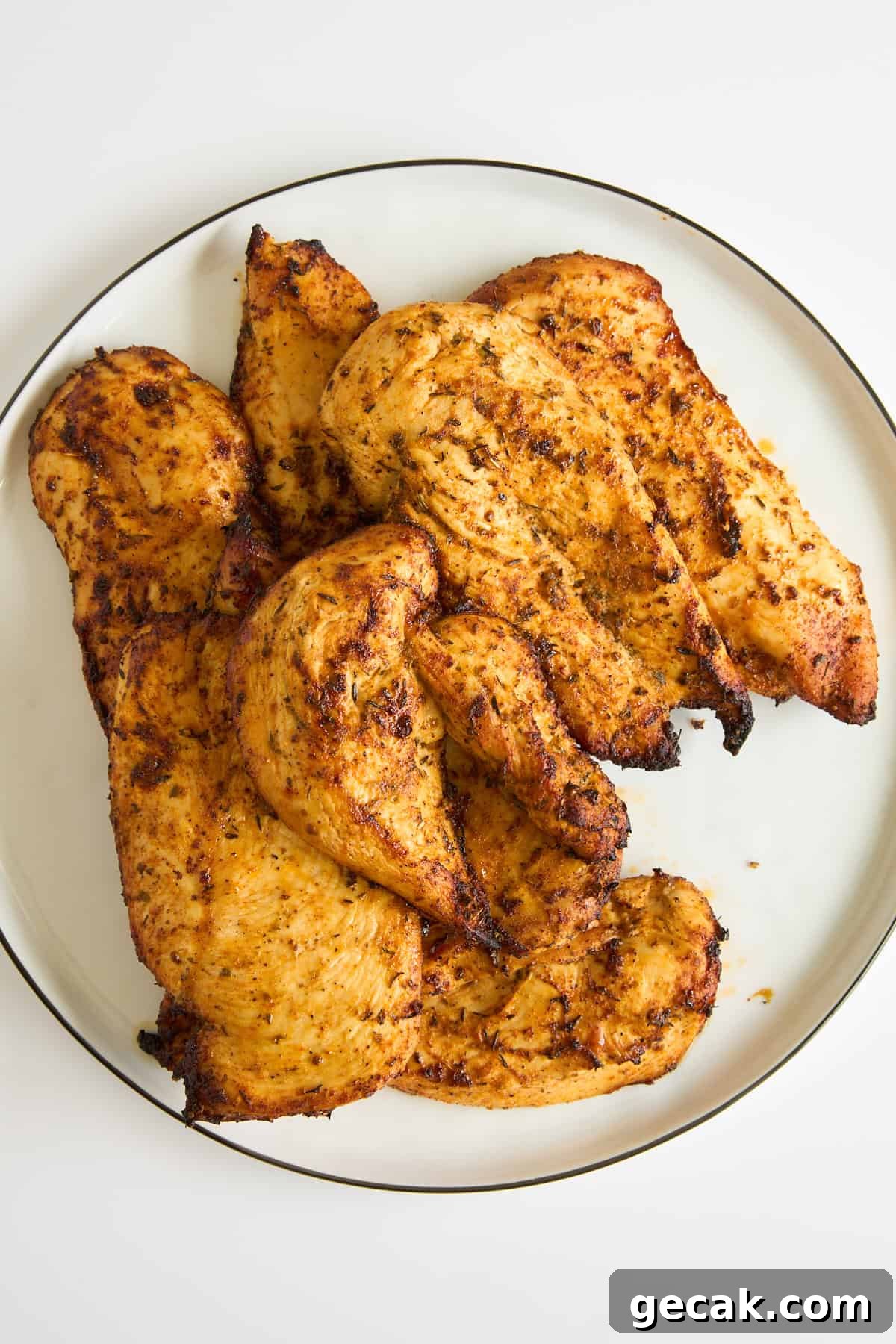 A plate of baked chicken breasts. 