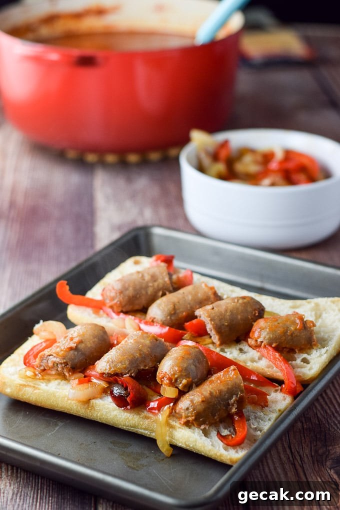 Sausage cut up and placed on the vegetables on the bread
