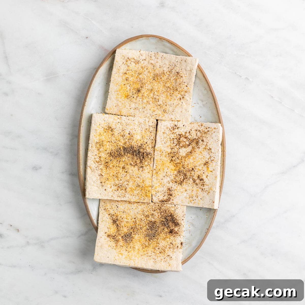 Seasoned tofu pieces on a plate.