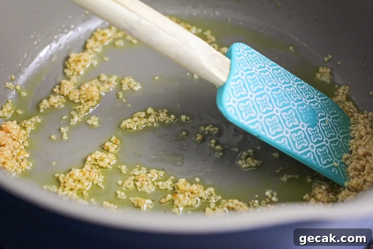 Minced garlic simmering in pan.