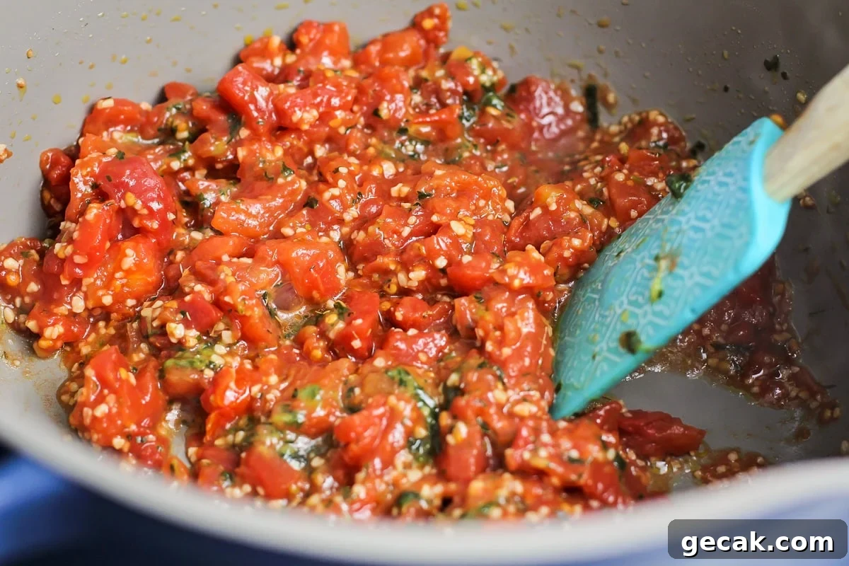 Ingredients for tomato soup in pan.