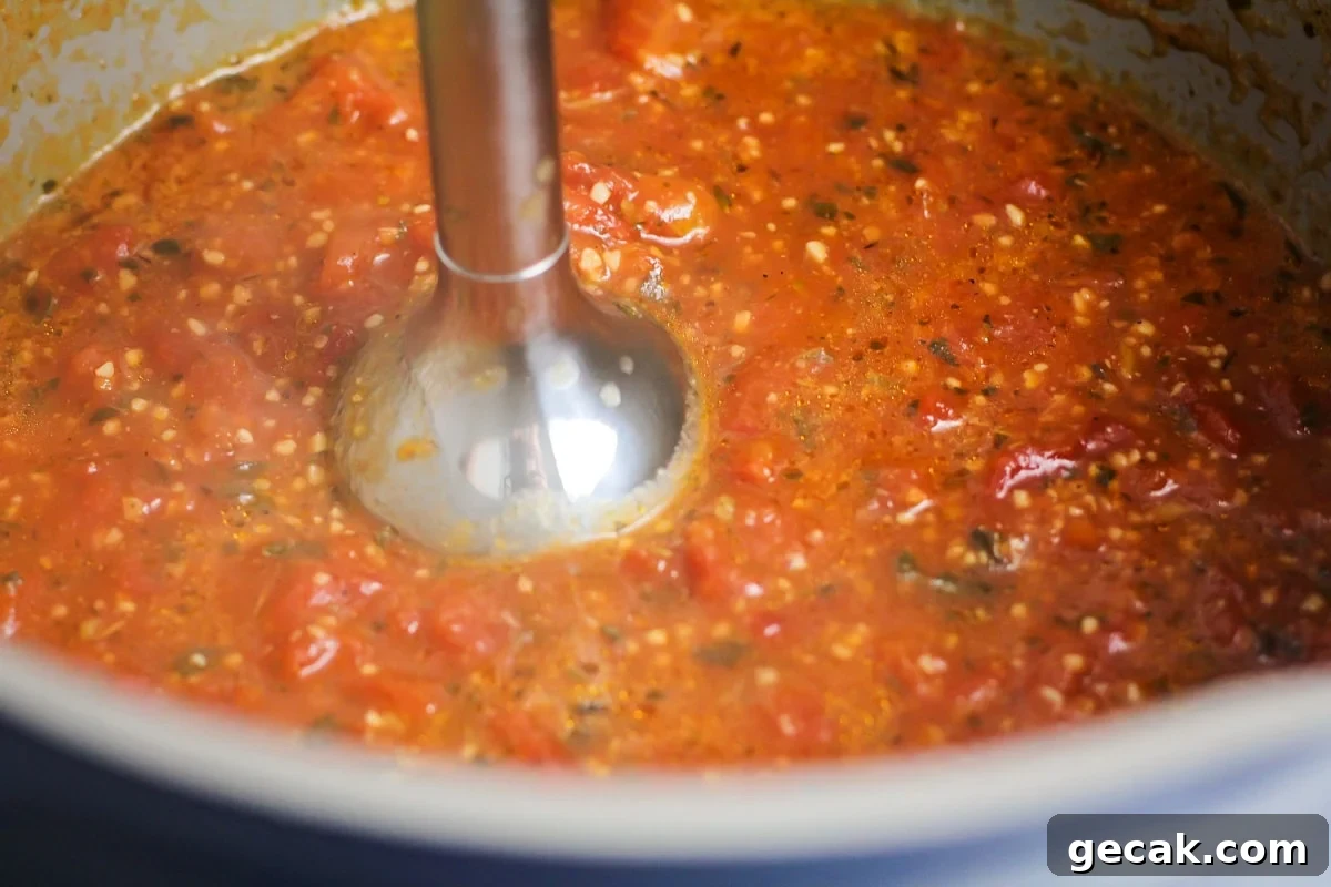 Ingredients for tomato basil soup being blended.