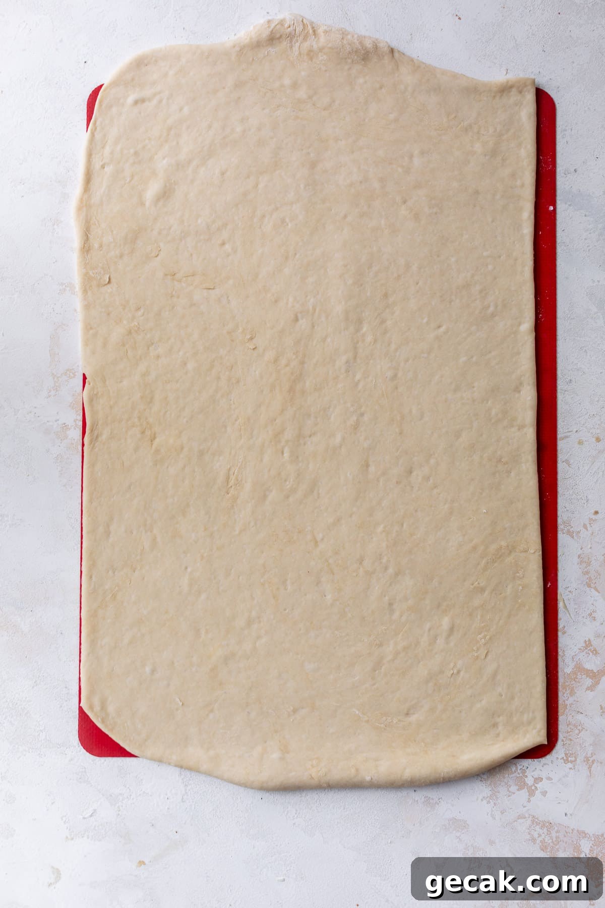 overhead view of vegan cinnamon roll dough rolled out into a rectangle.