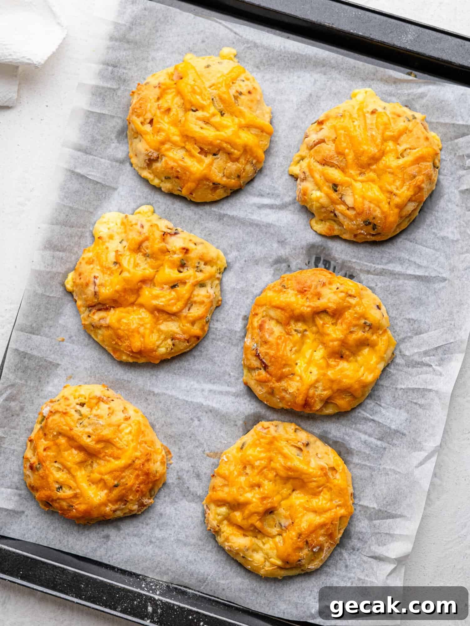 High-Protein Biscuits Without Butter — Fluffy, Low-Fat Recipe 8 Freshly baked breakfast biscuits on a baking tray.