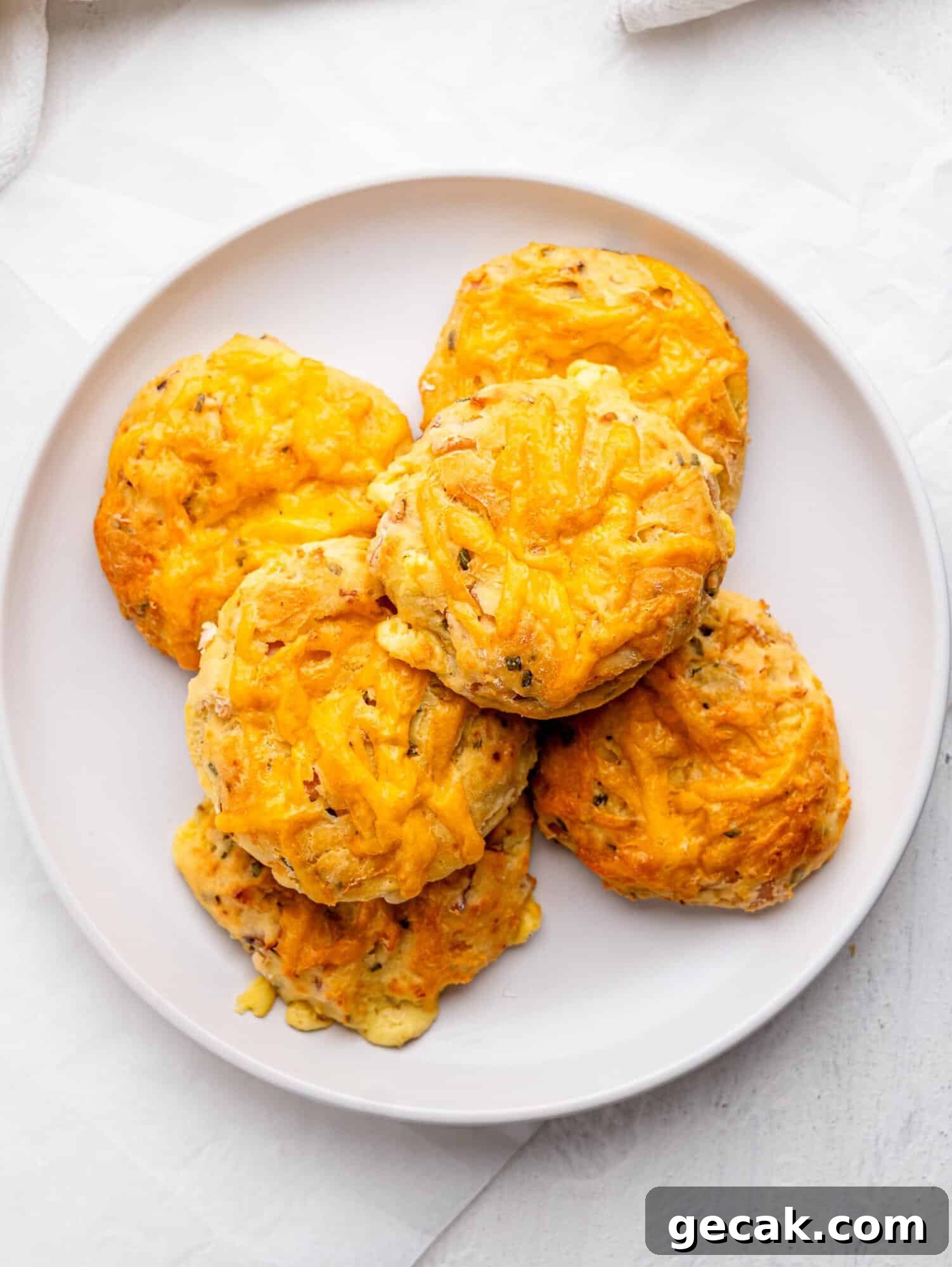 High-Protein Biscuits Without Butter — Fluffy, Low-Fat Recipe 6 Bird's eye view of six protein bagels on a white plate.