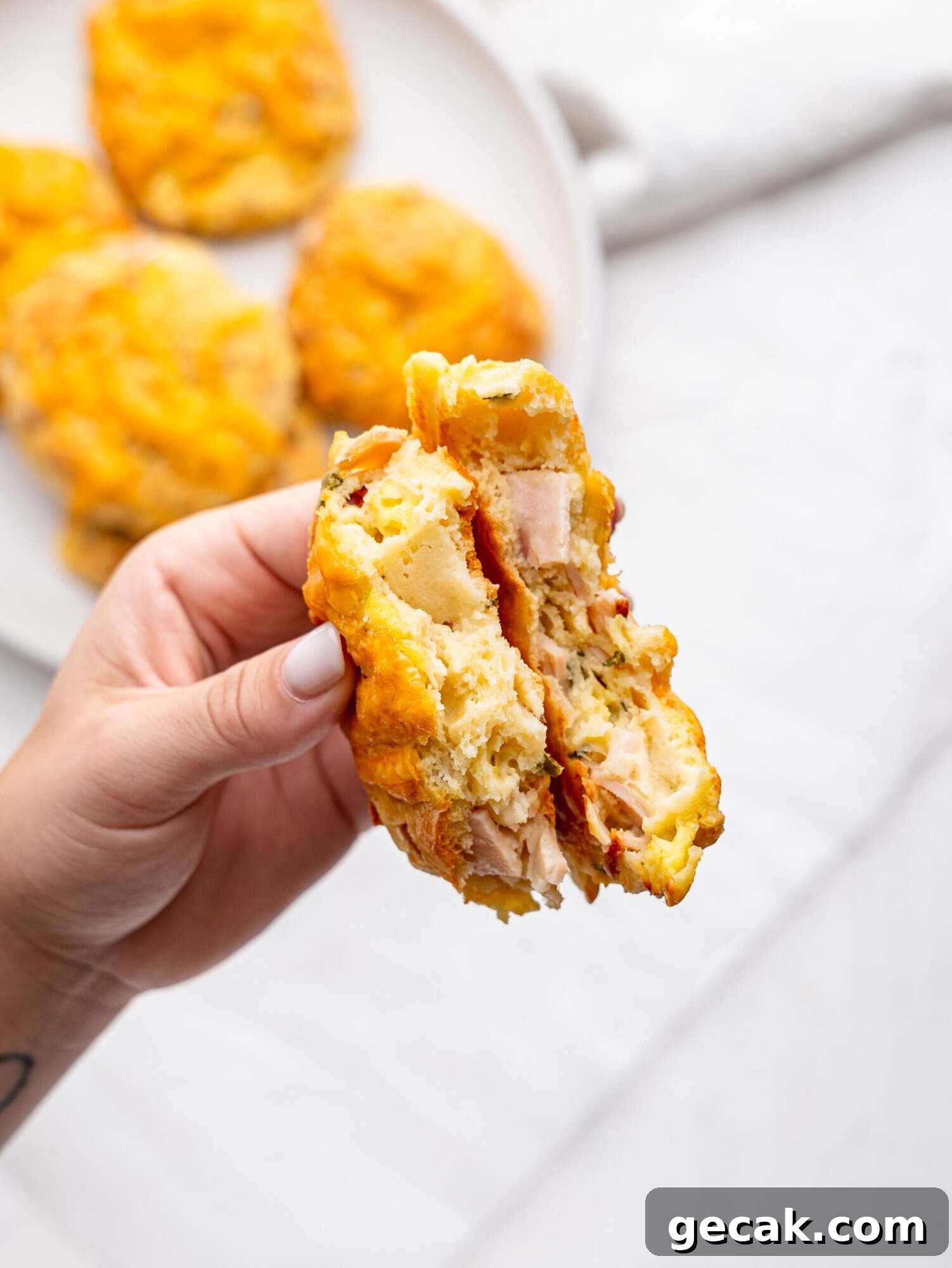 High-Protein Biscuits Without Butter — Fluffy, Low-Fat Recipe 7 A hand holding a protein bagel broken in half.