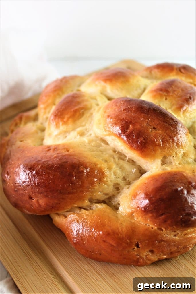 Gluten-Free Challah Recipe: Soft, Braided Loaf for Beginners 5 half of a round gluten free challah on wooden cutting board