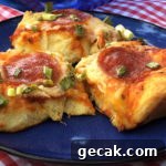 three pieces of easy biscuit pizza with pepperoni on a blue plate