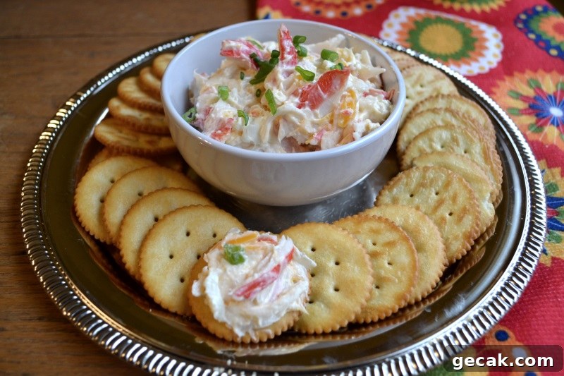 Mild Crab Dip in white bowl surrounded by crackers from www.ApronFreeCooking.com