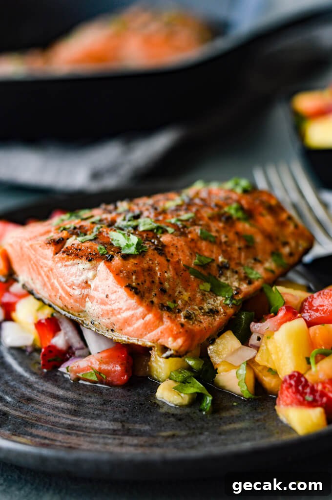 Pan Seared Sockeye Salmon with Fruit Salsa - Plated cooked sockeye salmon on a bed of fresh fruit salsa
