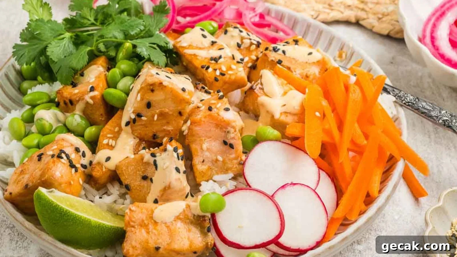 Air fryer salmon bites with crispy edges served with sriracha-lime dipping sauce.