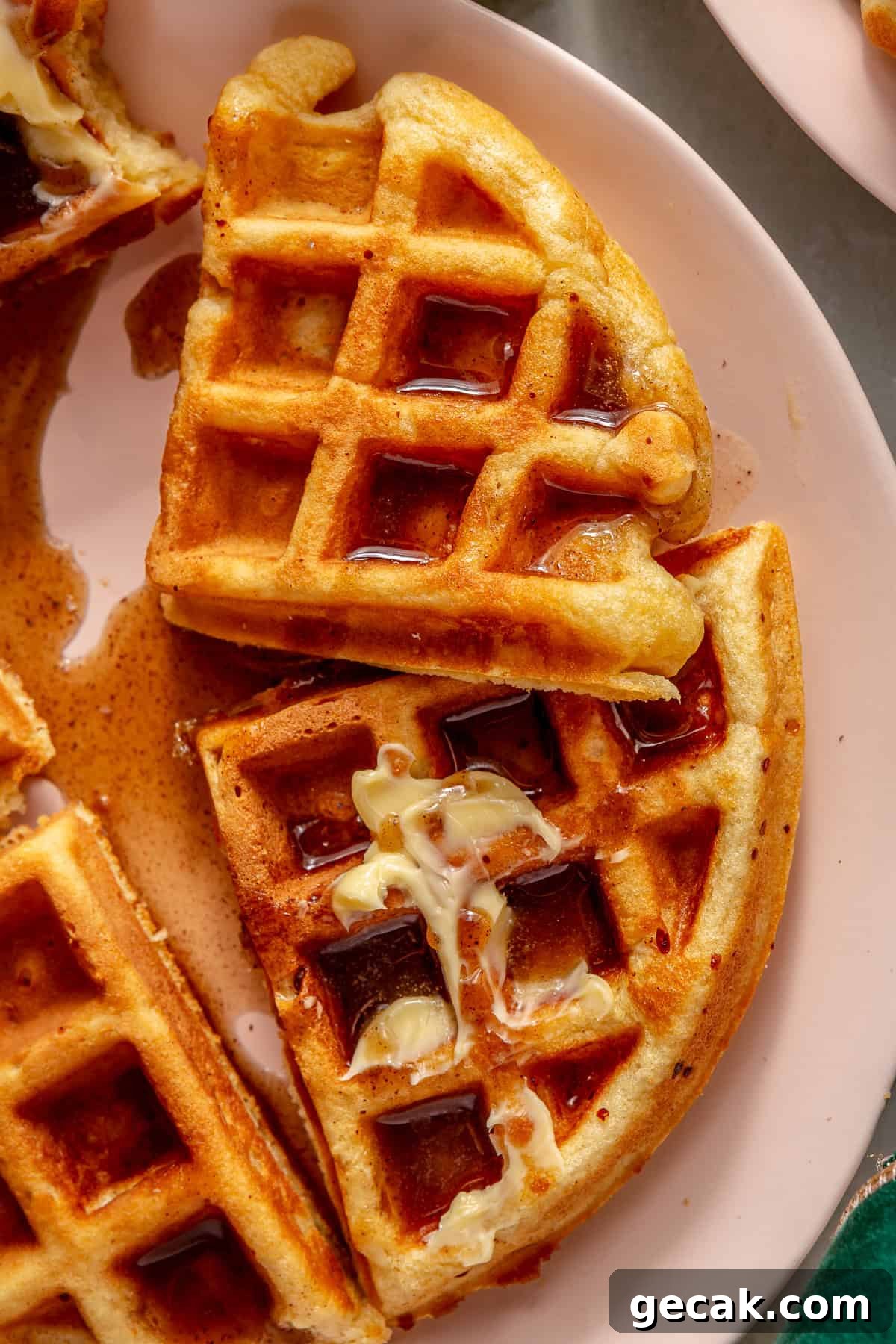 Eggnog waffles smeared with butter and drizzled with cinnamon syrup. 