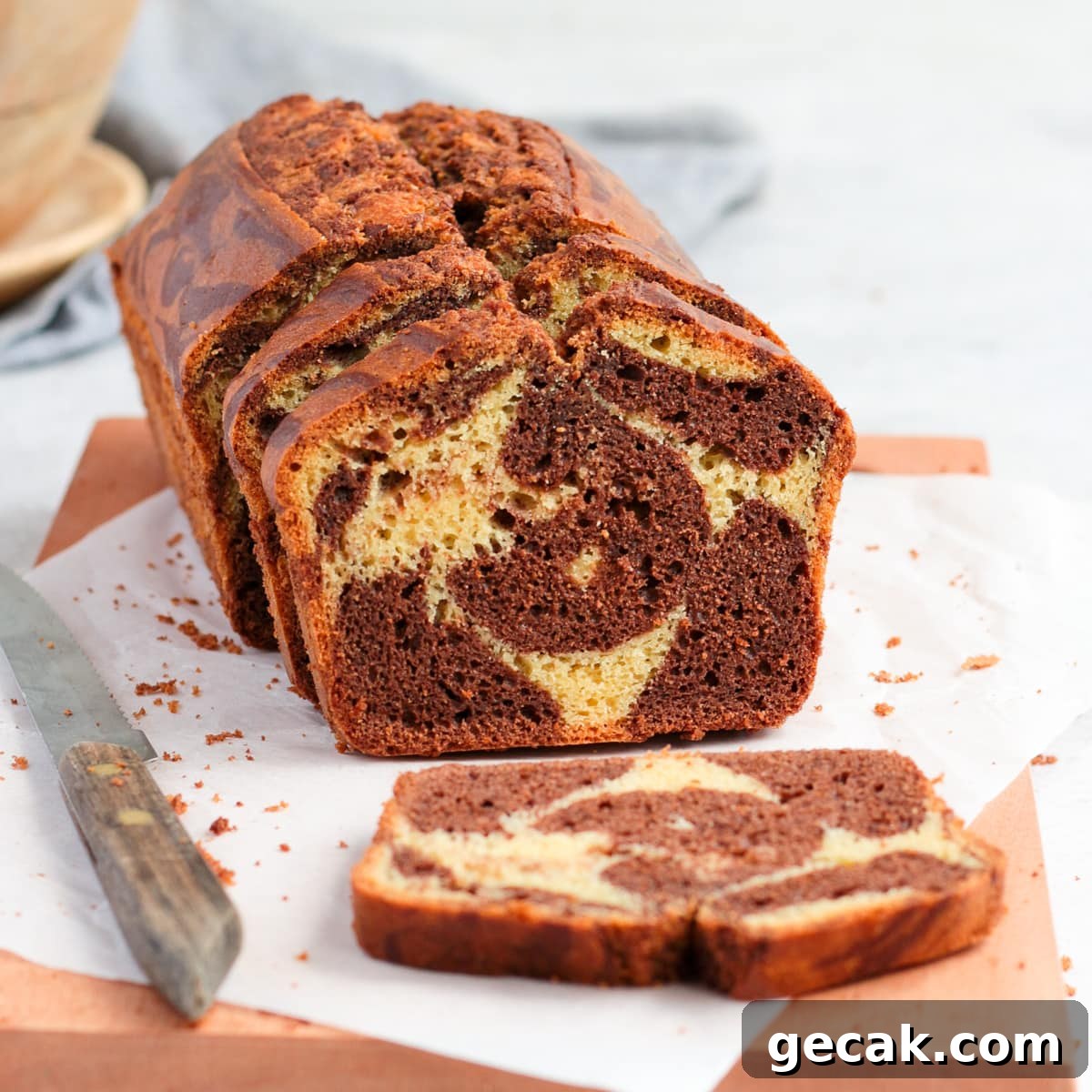 Cake on a wooden board with one slice down