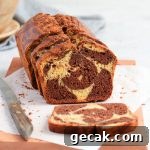Cake on a wooden board with one slice down