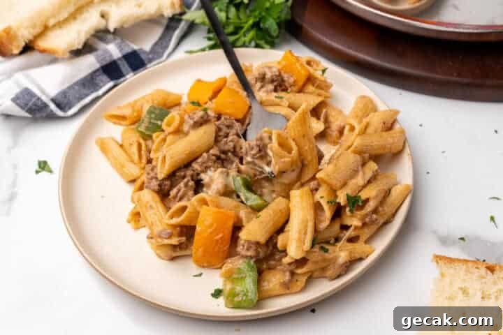 Philly Cheesesteak Pasta served on a white plate.
