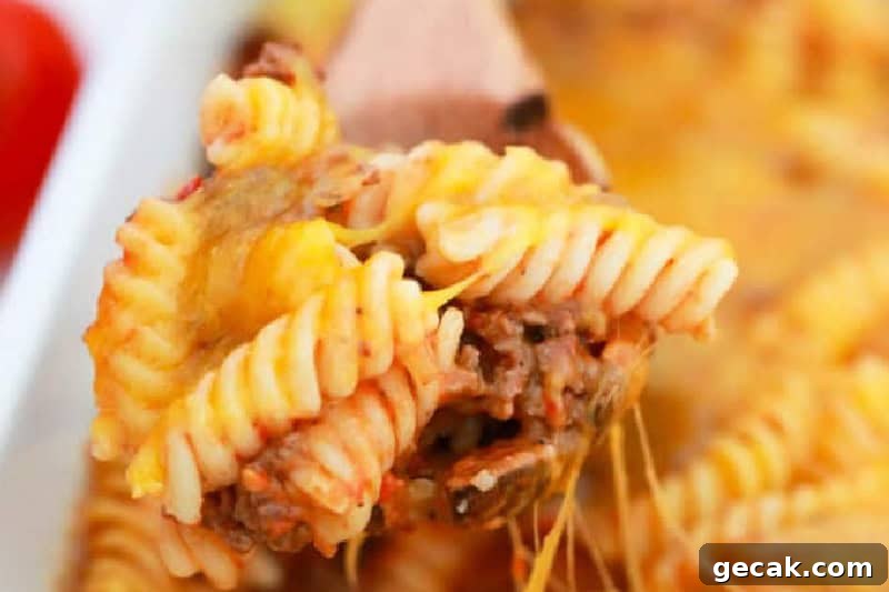 closeup of the Cheeseburger Casserole on a wooden spoon.