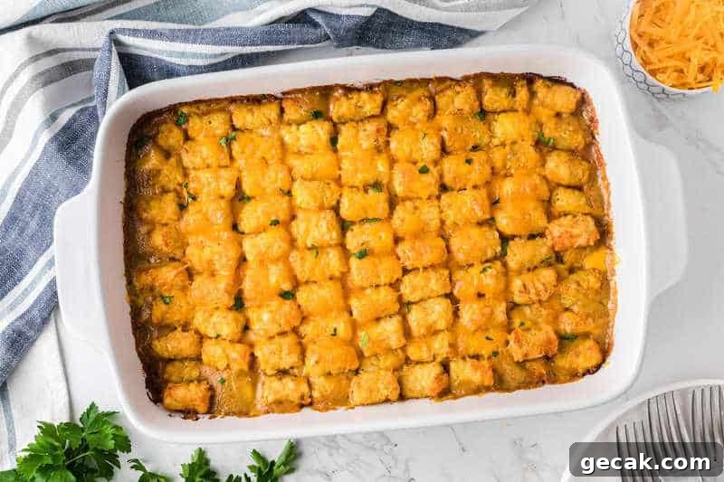 tater Tot Casserole served in a white casserole dish.