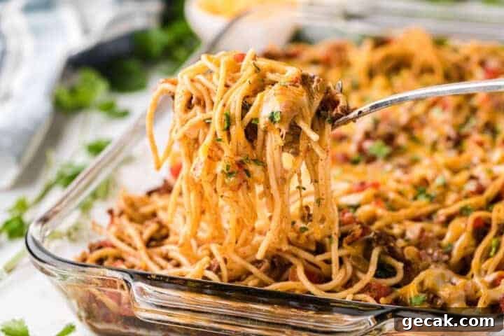 Taco Spaghetti being served of a glass baking dish.
