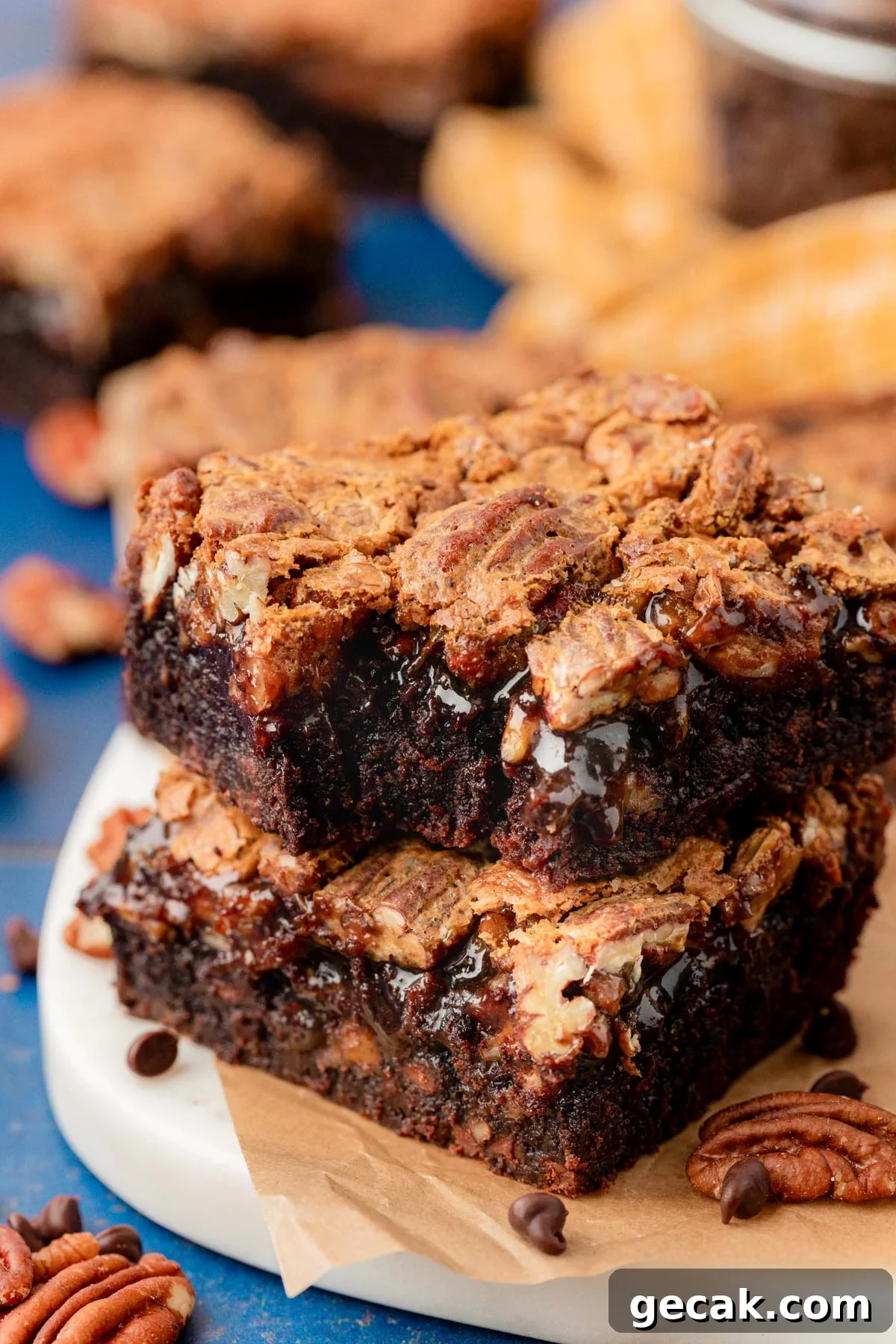 Close up of pecan pie brownies stacked on a plate.