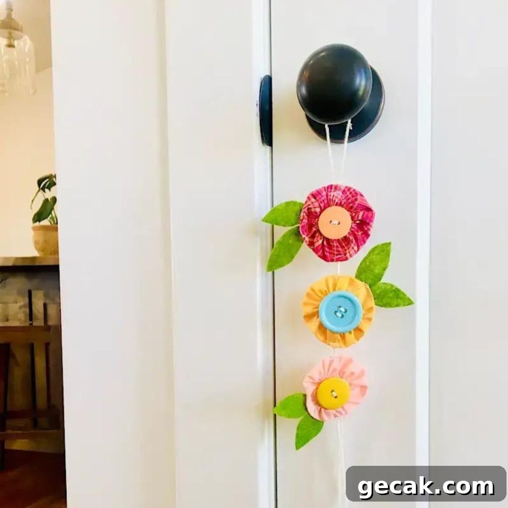 16 Creative Button Craft Ideas for Endless DIY Fun 12 Fabric Yoyo Flowers hang on a door knob