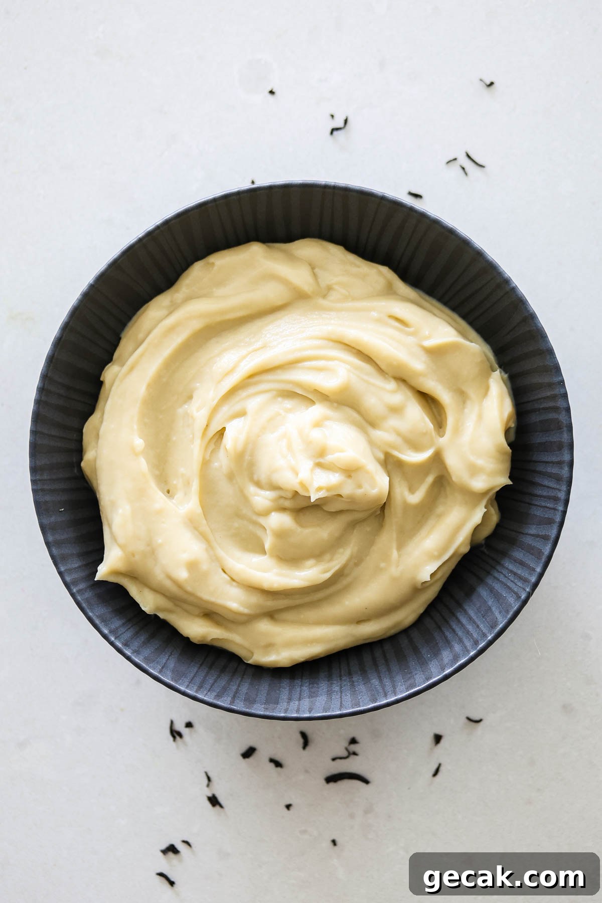 Earl Grey custard in a black bowl.