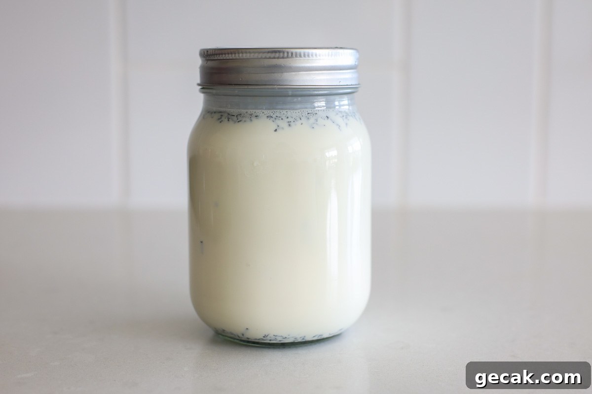 Cream mixture with Earl Grey loose tea in a glass jar with lid.