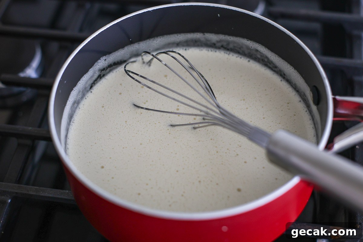 Cream mixture in a pan with whisk.