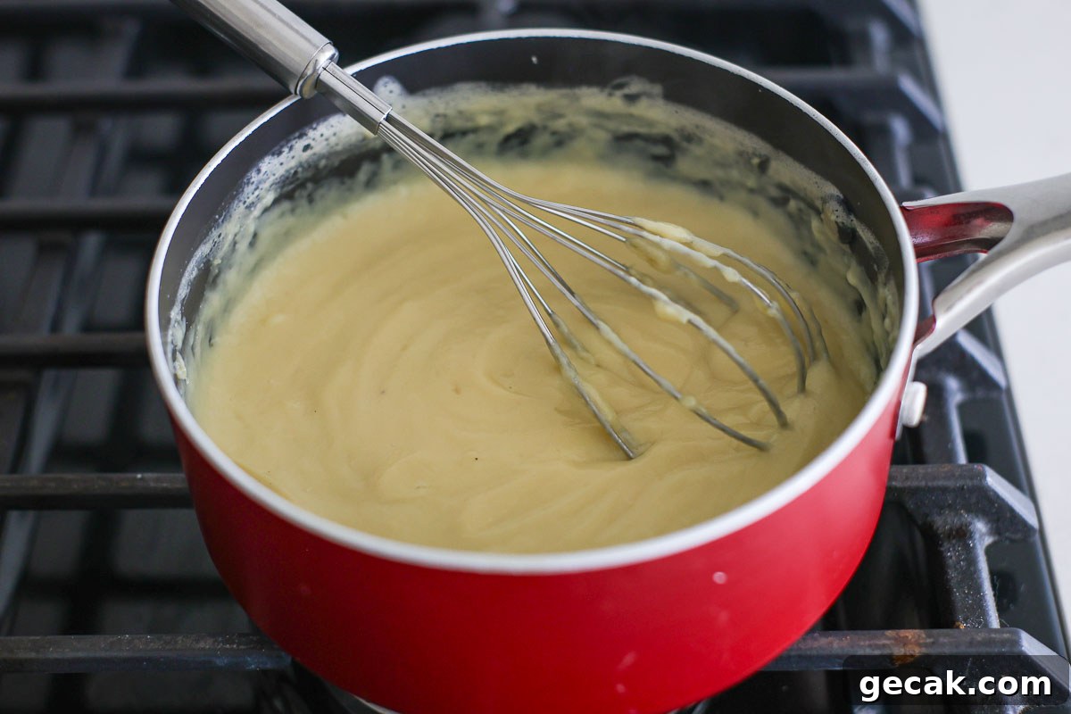 Custard ready in a pan with whisk.