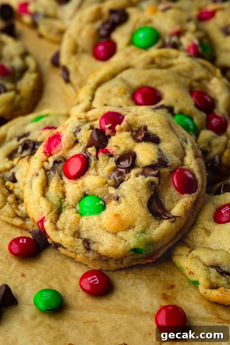 a photo of a pile of golden baked chocolate chip m&m Christmas cookies.