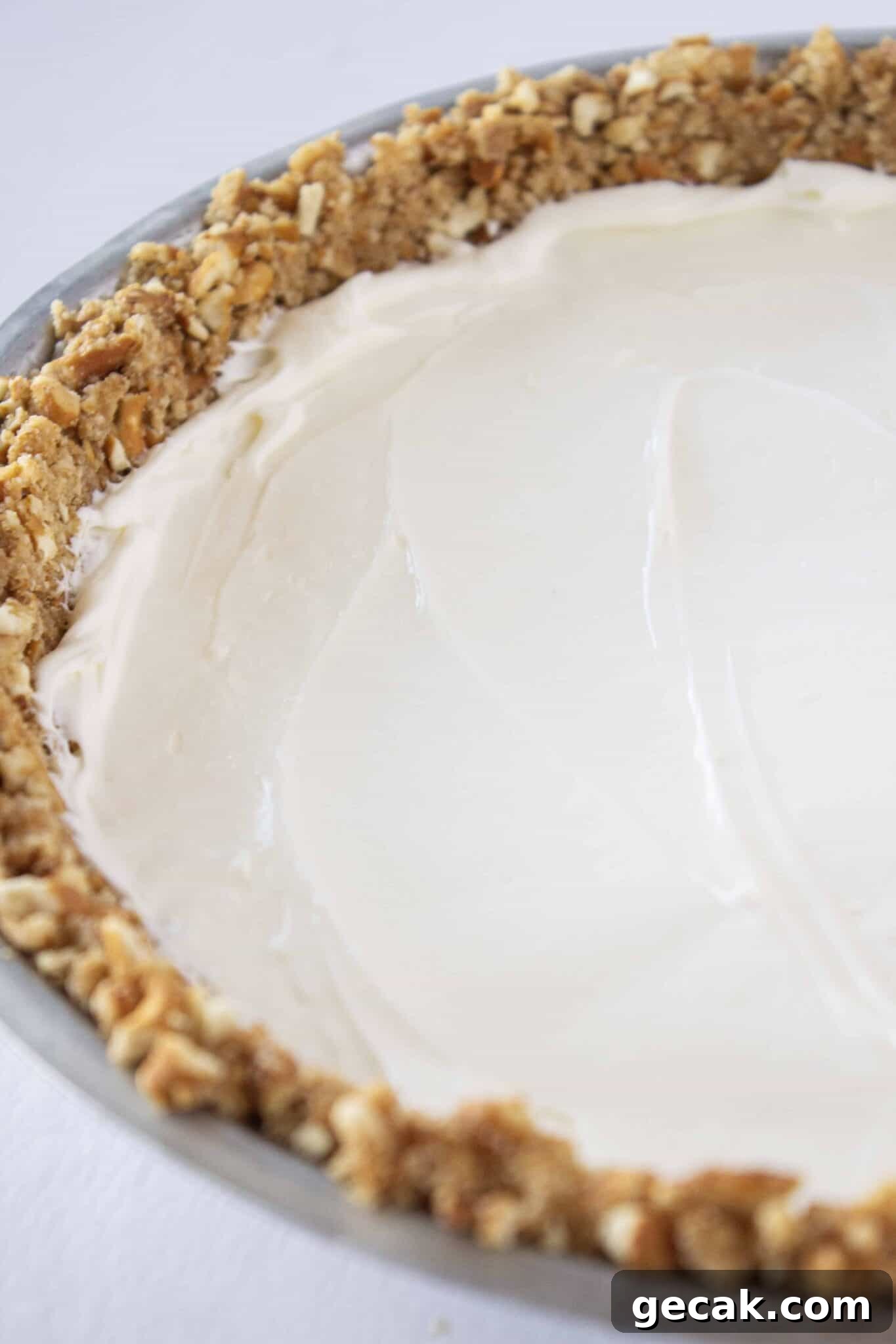 Making the cream cheese layer and adding it to the pretzel pie crust.