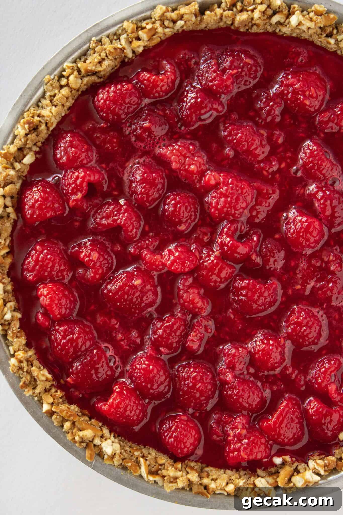 Making the raspberry jello topping and adding it to the top of the cream cheese layer.