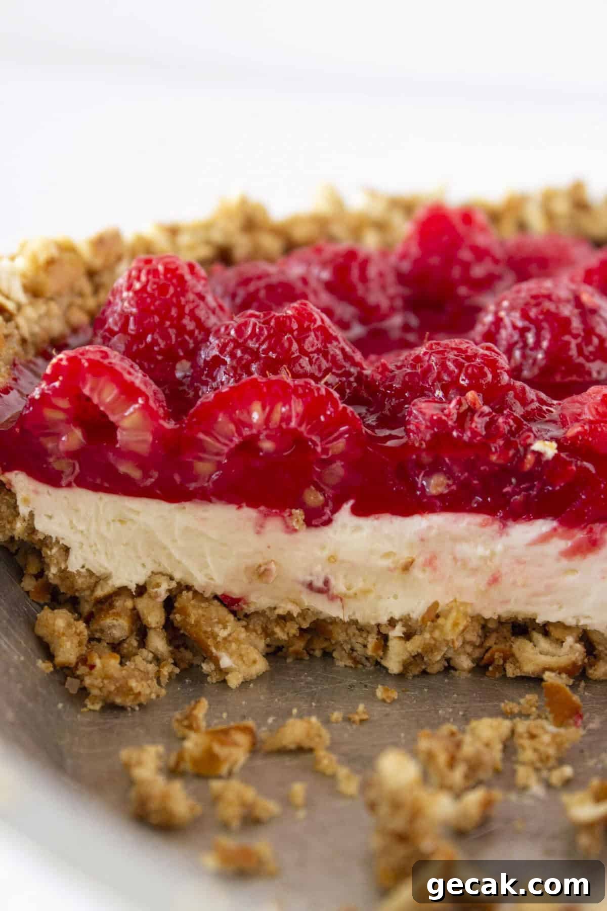 Looking at the inside of a Raspberry Pretzel Pie with cheesecake filling.