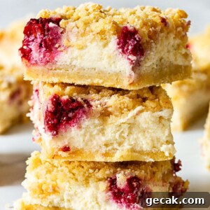 3 raspberry cheesecake bars stacked on top on each other