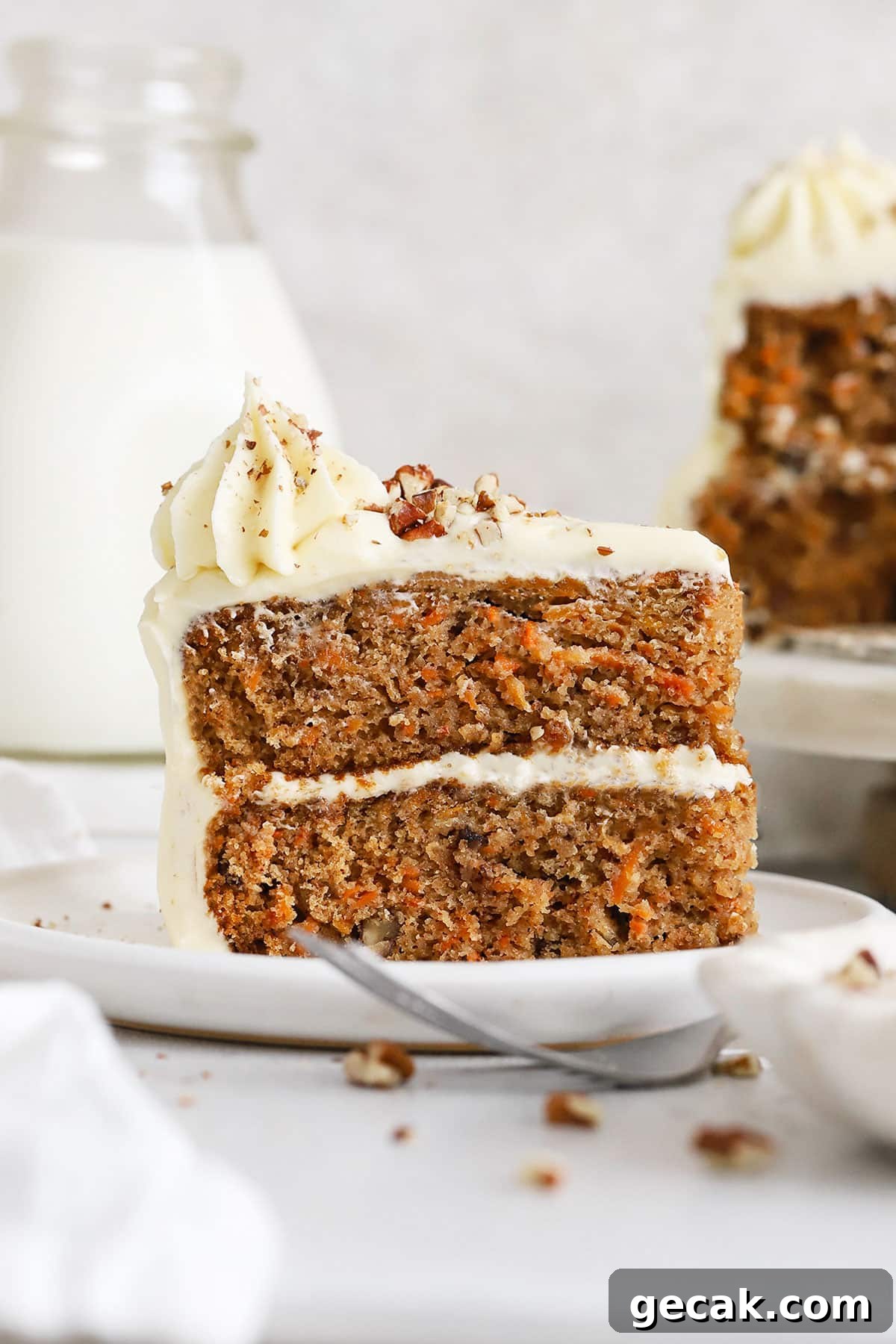 a slice of gluten-free carrot layer cake on a white plate