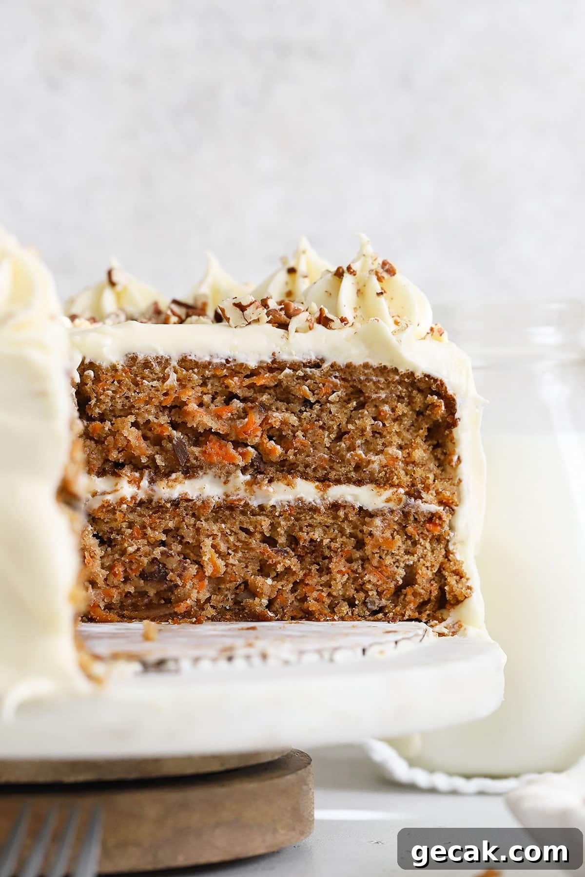 An inside view of a two-layer gluten-free carrot cake with cream cheese frosting