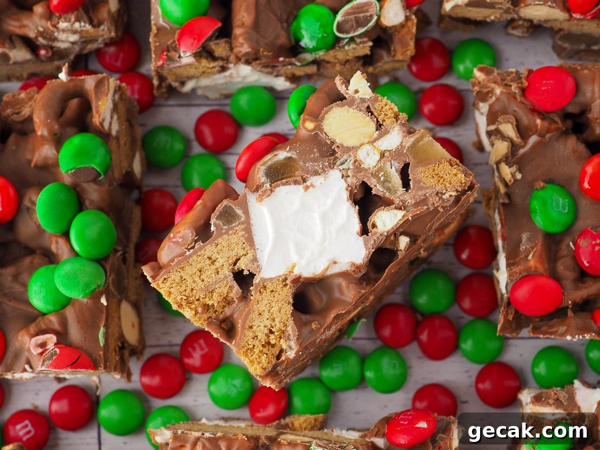 Cut up pieces of rocky road, with center slice turned up showing cut edge and red and green candy.
