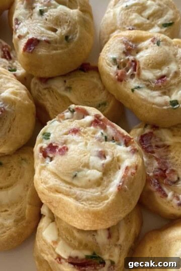 bacon cream cheese crescent rolls stacked on white plate