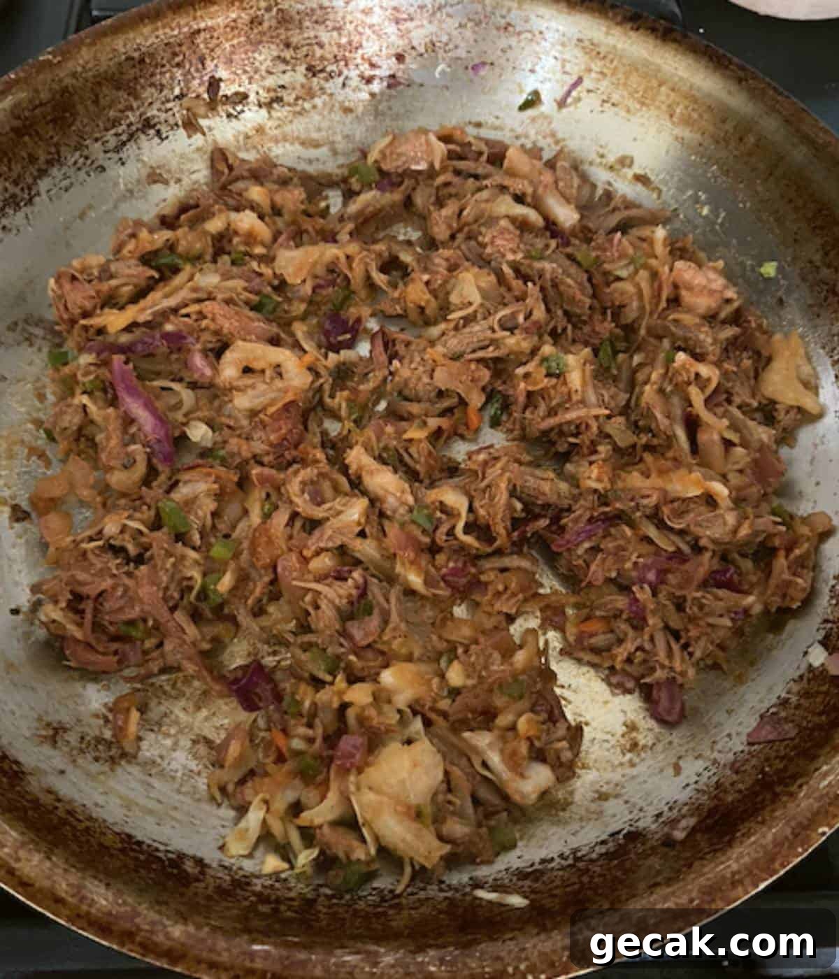 BBQ Pulled Pork Egg Rolls (Southern-Style Redneck Egg Rolls) 6 Pork filling with bbq sauce cooking in skillet.